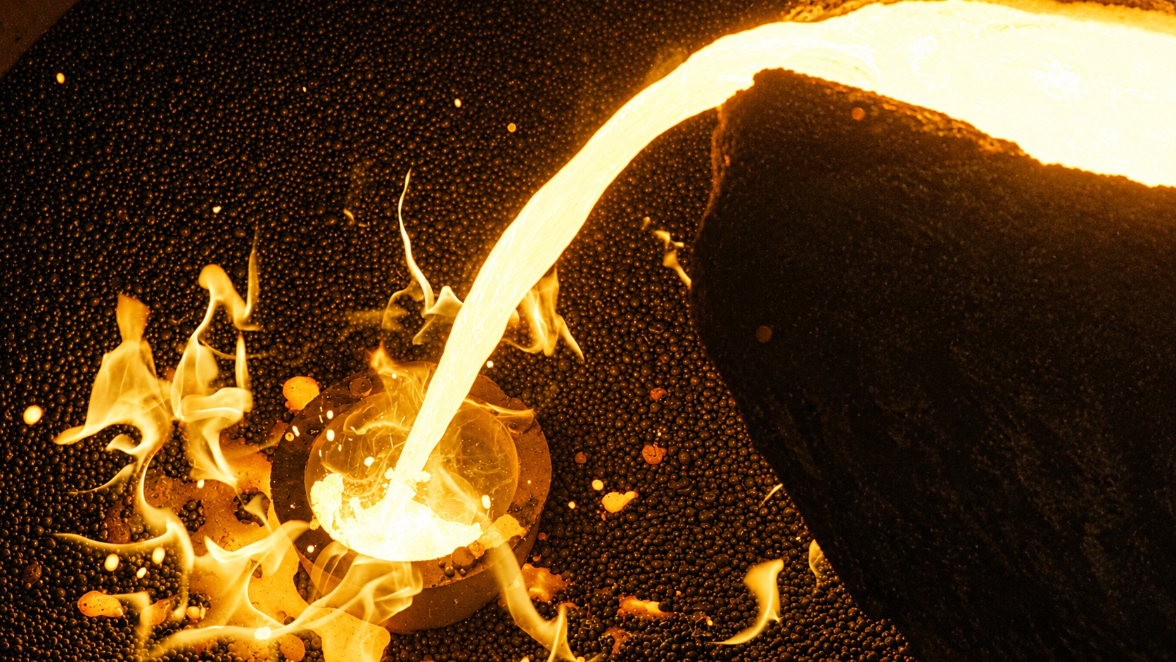 Molten metal being poured into casting molds